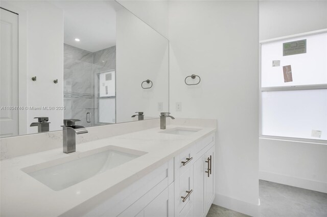 935 Elgin St, Lehigh Acres, FL 33974 - bathroom featuring baseboards, a shower stall, and double vanity