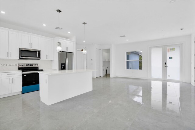935 Elgin St, Lehigh Acres, FL 33974 - kitchen featuring stainless steel appliances, recessed lighting, a kitchen island, light countertops, and light tile patterned floors