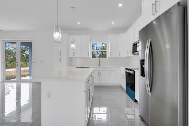 935 Elgin St, Lehigh Acres, FL 33974 - kitchen featuring appliances with stainless steel finishes, recessed lighting, a center island, light countertops, and white cabinets