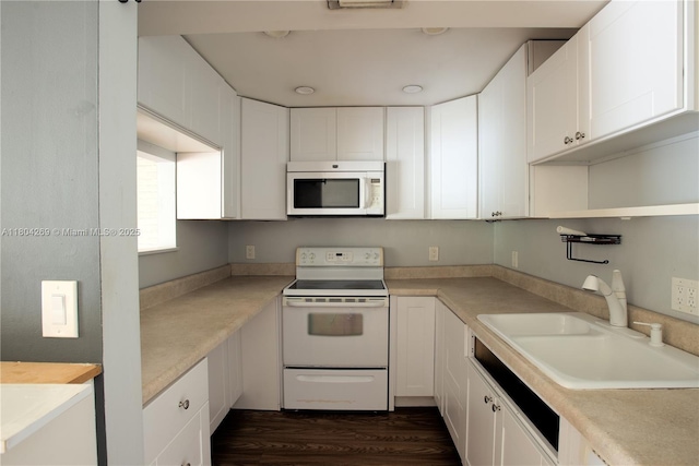 4200 Crystal Lake Dr Unit 204, Deerfield Beach, FL 33064 - kitchen featuring white appliances, a sink, white cabinets, light countertops, and dark wood-style flooring