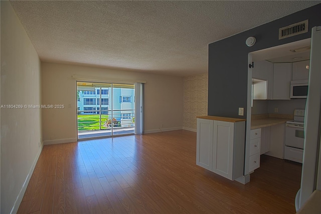 4200 Crystal Lake Dr Unit 204, Deerfield Beach, FL 33064 - unfurnished room with a textured ceiling, wood finished floors, baseboards, and a smoke detector