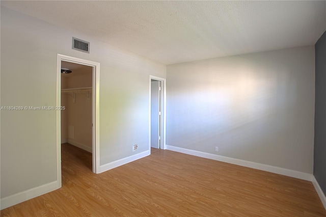 4200 Crystal Lake Dr Unit 204, Deerfield Beach, FL 33064 - unfurnished bedroom with light wood-type flooring, a spacious closet, baseboards, and a closet