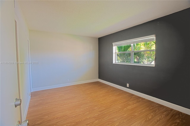 4200 Crystal Lake Dr Unit 204, Deerfield Beach, FL 33064 - spare room featuring light wood-style floors, a textured ceiling, and baseboards