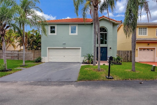view of front of home featuring a garage, a tile roof, asphalt driveway, and stucco siding