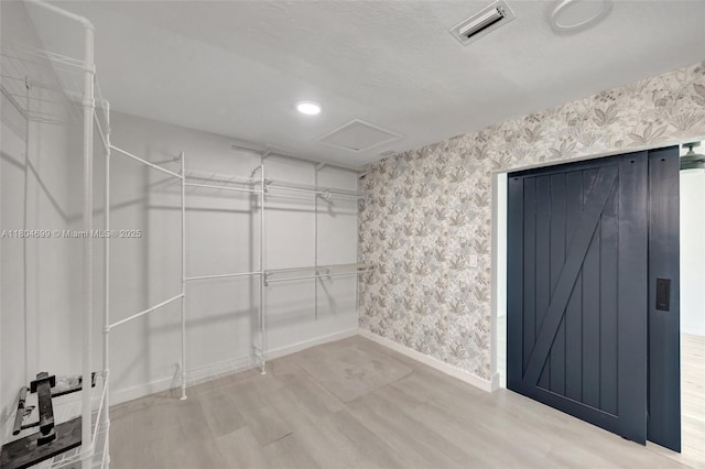 walk in closet featuring wood finished floors