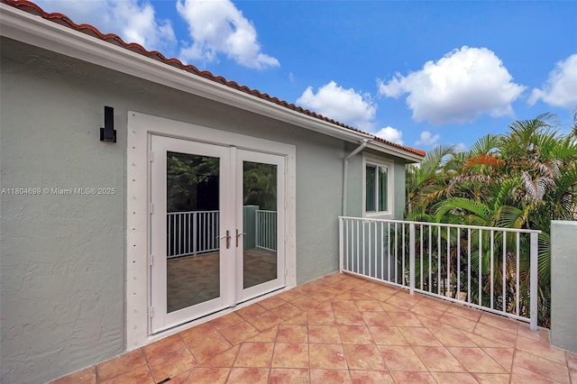 view of patio featuring french doors and a balcony