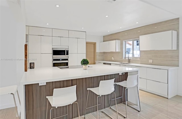 2341 Keystone, North Miami, FL 33181 - kitchen featuring stainless steel appliances, a sink, modern cabinets, a peninsula, and white cabinetry