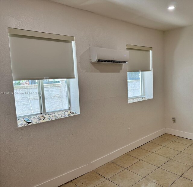 1021 NW 3rd St Unit 106, Miami, FL 33128 - empty room with an AC wall unit, healthy amount of natural light, light tile patterned floors, baseboards, and recessed lighting