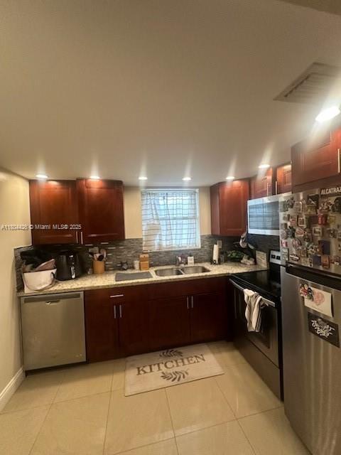 9351 Fontainebleau Blvd Unit B122, Miami, FL 33172 - kitchen with appliances with stainless steel finishes, decorative backsplash, light tile patterned flooring, and light countertops