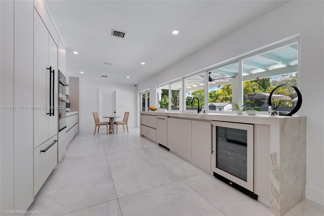 7843 SW 166th St, Palmetto Bay, FL 33157 - kitchen with beverage cooler, modern cabinets, white cabinets, and recessed lighting