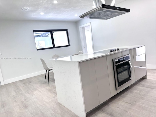 2421 N 56th Ter, Hollywood, FL 33021 - kitchen with range hood, oven, modern cabinets, light wood-style flooring, and recessed lighting