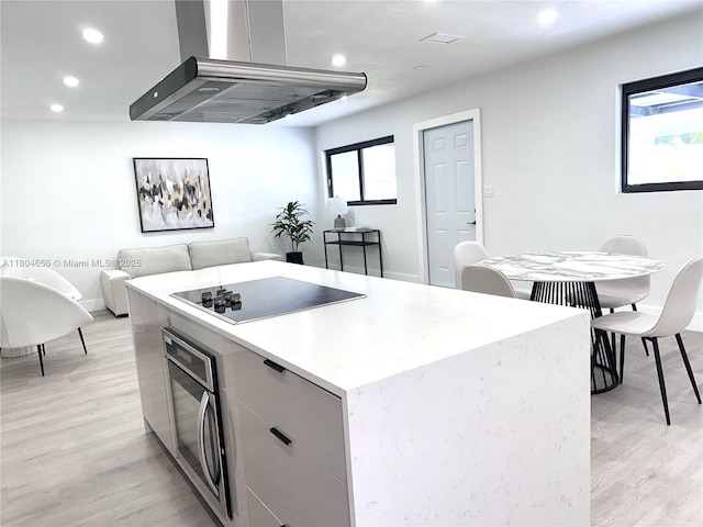 2421 N 56th Ter, Hollywood, FL 33021 - kitchen with black electric cooktop, extractor fan, recessed lighting, light wood-style floors, and gray cabinetry