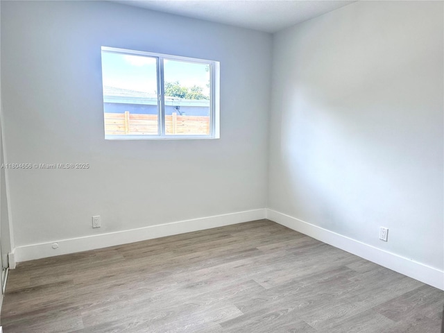2421 N 56th Ter, Hollywood, FL 33021 - unfurnished bedroom with wood finished floors and baseboards