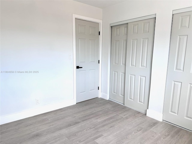 2421 N 56th Ter, Hollywood, FL 33021 - unfurnished bedroom featuring wood finished floors and baseboards
