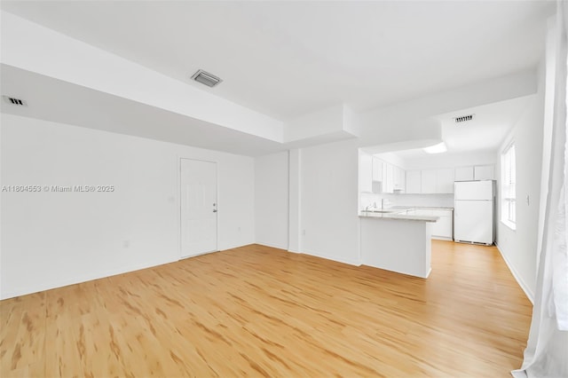 1051 Meridian Ave Unit 1D, Miami Beach, FL 33139 - unfurnished living room featuring light wood finished floors