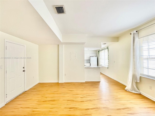 1051 Meridian Ave Unit 1D, Miami Beach, FL 33139 - unfurnished living room with light wood finished floors, healthy amount of natural light, and baseboards