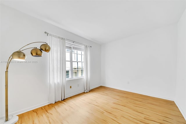 1051 Meridian Ave Unit 1D, Miami Beach, FL 33139 - spare room featuring wood finished floors and baseboards