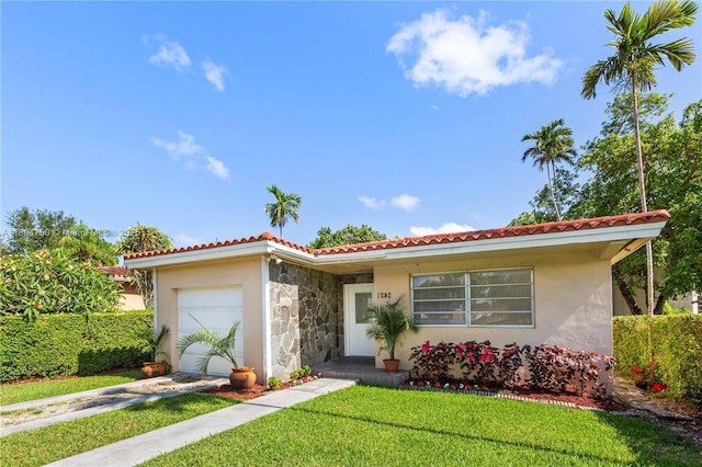 1242 Sevilla Ave, Coral Gables, FL 33134 - view of front of house with an attached garage, a tiled roof, stucco siding, and a front lawn