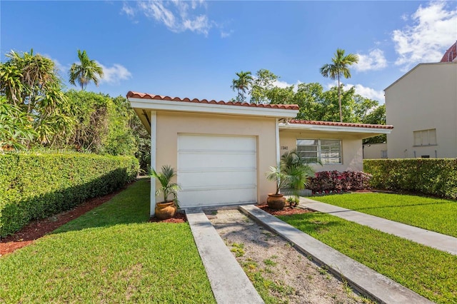 1242 Sevilla Ave, Coral Gables, FL 33134 - mediterranean / spanish home featuring concrete driveway, a tiled roof, stucco siding, a front yard, and an attached garage
