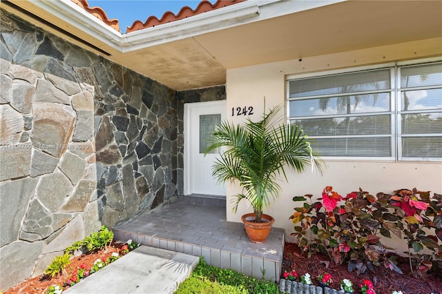 1242 Sevilla Ave, Coral Gables, FL 33134 - doorway to property featuring stone siding and a tile roof