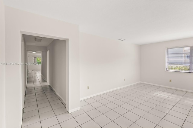 1242 Sevilla Ave, Coral Gables, FL 33134 - spare room with light tile patterned flooring and baseboards
