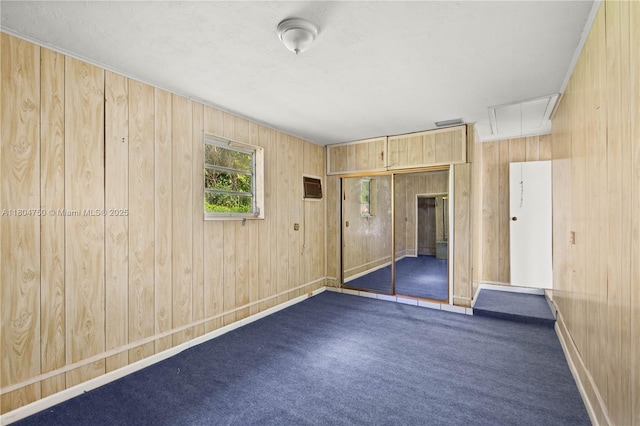 1242 Sevilla Ave, Coral Gables, FL 33134 - carpeted spare room with attic access, wooden walls, and baseboards