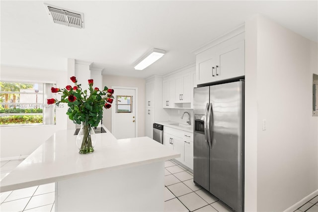 1242 Sevilla Ave, Coral Gables, FL 33134 - kitchen with appliances with stainless steel finishes, a sink, light countertops, and white cabinets