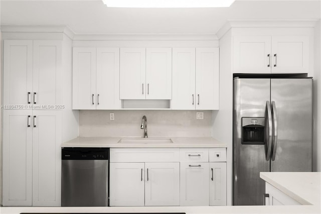1242 Sevilla Ave, Coral Gables, FL 33134 - kitchen with appliances with stainless steel finishes, a sink, white cabinets, and light countertops