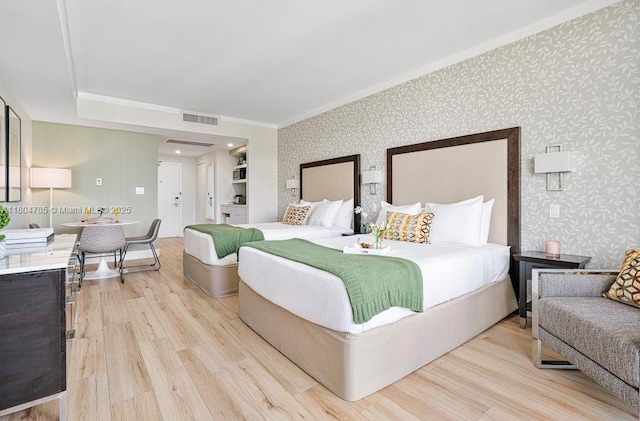 2889 Mcfarlane Rd Unit 1403, Miami, FL 33133 - bedroom with wallpapered walls, light wood finished floors, and crown molding