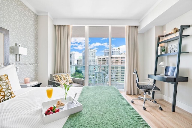 2889 Mcfarlane Rd Unit 1403, Miami, FL 33133 - bedroom featuring wood finished floors, a skyline view, baseboards, wallpapered walls, and ornamental molding