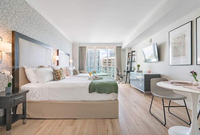 2889 Mcfarlane Rd Unit 1403, Miami, FL 33133 - bedroom featuring wallpapered walls and wood finished floors