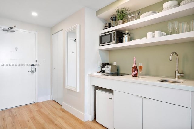 2889 Mcfarlane Rd Unit 1403, Miami, FL 33133 - bar featuring stainless steel microwave, light wood finished floors, a sink, baseboards, and recessed lighting