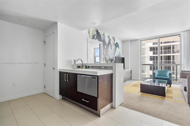 17315 Collins Ave Unit 1008, Sunny Isles Beach, FL 33160 - kitchen featuring a sink, light countertops, open floor plan, and baseboards