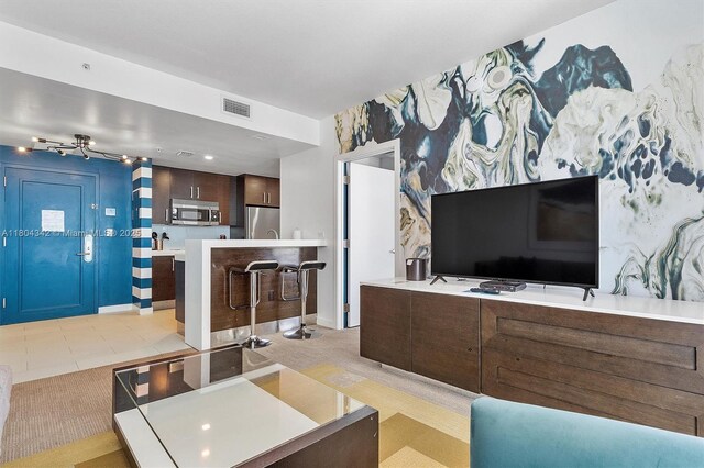 17315 Collins Ave Unit 1008, Sunny Isles Beach, FL 33160 - living area with wallpapered walls, an accent wall, and baseboards