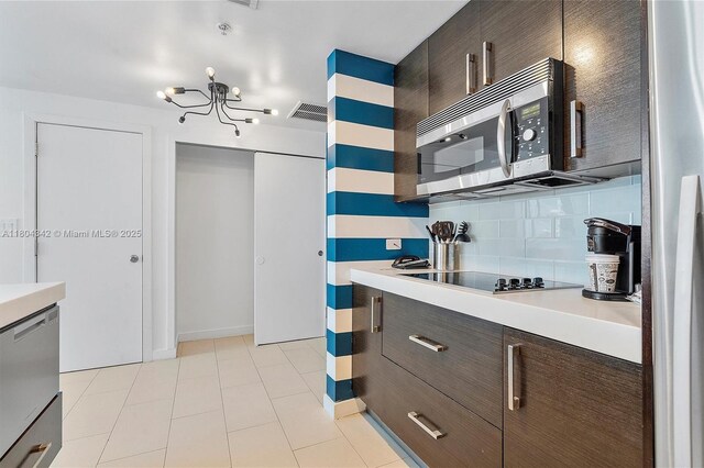 17315 Collins Ave Unit 1008, Sunny Isles Beach, FL 33160 - kitchen with appliances with stainless steel finishes, light countertops, a chandelier, and dark brown cabinets
