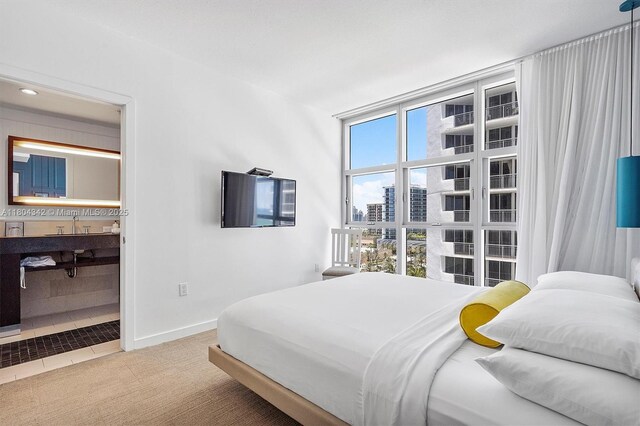 17315 Collins Ave Unit 1008, Sunny Isles Beach, FL 33160 - carpeted bedroom with baseboards, a wall of windows, and ensuite bathroom
