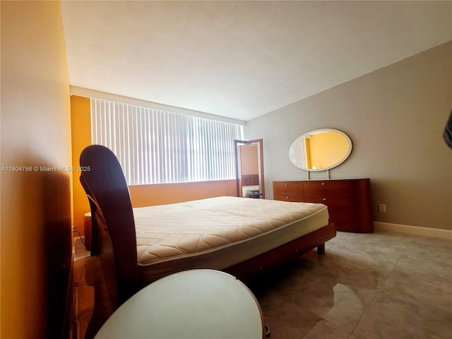 16565 NE 26th Ave Unit 2B, North Miami Beach, FL 33160 - bedroom with lofted ceiling and baseboards