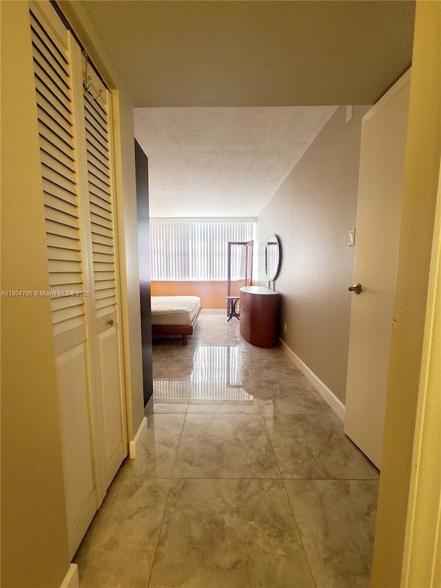 16565 NE 26th Ave Unit 2B, North Miami Beach, FL 33160 - hallway featuring baseboards