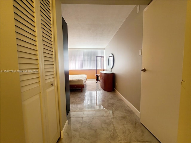 16565 NE 26th Ave Unit 2B, North Miami Beach, FL 33160 - corridor featuring concrete floors and baseboards