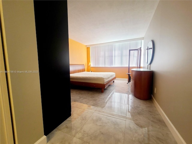 16565 NE 26th Ave Unit 2B, North Miami Beach, FL 33160 - bedroom featuring baseboards