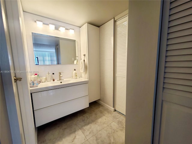 16565 NE 26th Ave Unit 2B, North Miami Beach, FL 33160 - bathroom with vanity and decorative backsplash