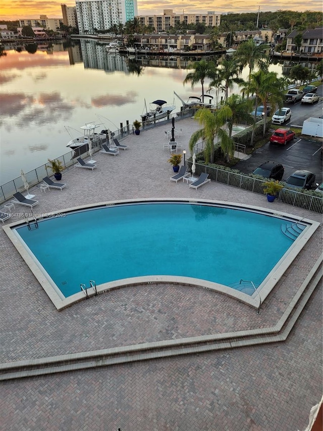 16565 NE 26th Ave Unit 2B, North Miami Beach, FL 33160 - community pool with fence, a water view, and a patio area