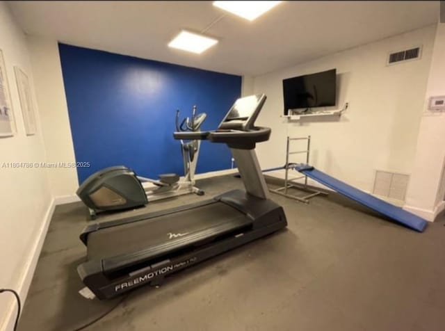 16565 NE 26th Ave Unit 2B, North Miami Beach, FL 33160 - exercise room featuring baseboards
