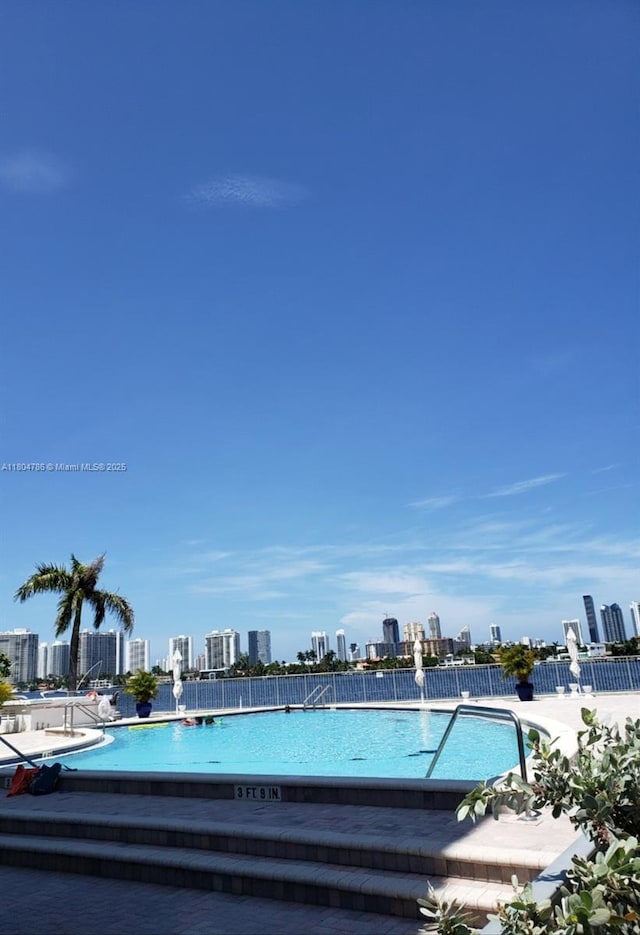16565 NE 26th Ave Unit 2B, North Miami Beach, FL 33160 - community pool featuring a view of skyline and fence