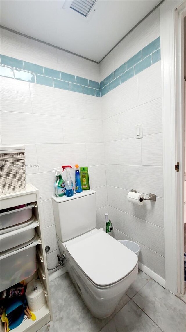16565 NE 26th Ave Unit 2B, North Miami Beach, FL 33160 - bathroom with toilet and tile walls