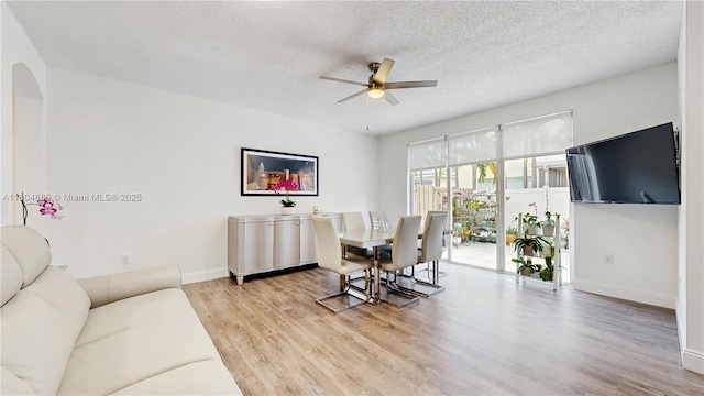 2250 NE 42nd Cir, Homestead, FL 33033 - living area featuring ceiling fan, wood finished floors, a textured ceiling, baseboards, and arched walkways