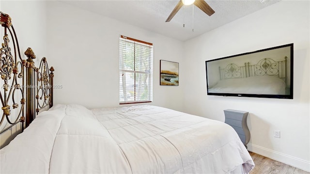 2250 NE 42nd Cir, Homestead, FL 33033 - bedroom featuring wood finished floors, baseboards, a textured ceiling, and a ceiling fan