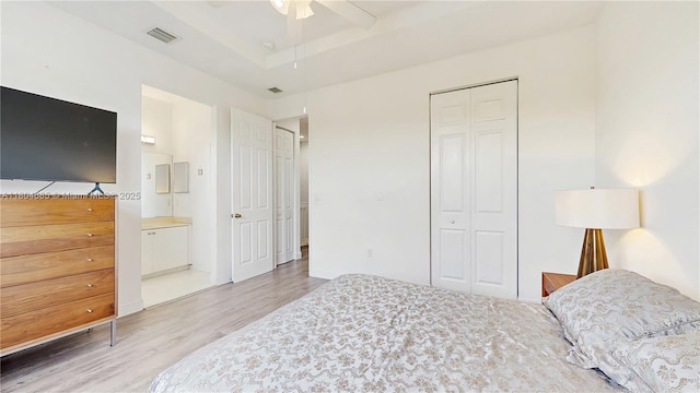 2250 NE 42nd Cir, Homestead, FL 33033 - bedroom featuring light wood-type flooring, a closet, connected bathroom, and a ceiling fan