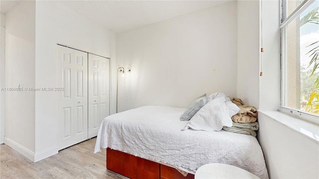 2250 NE 42nd Cir, Homestead, FL 33033 - bedroom featuring light wood-style floors, a closet, and baseboards
