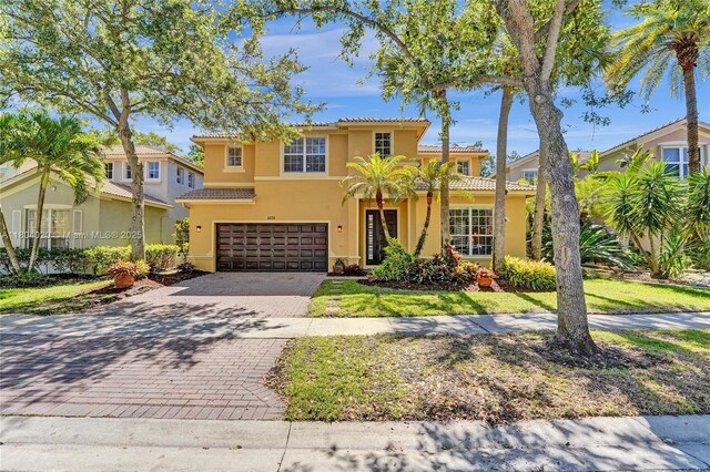 4470 E Seneca Ave, Weston, FL 33332 - mediterranean / spanish home featuring a tile roof, stucco siding, and a garage